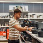 Man buying cooking pot in shop