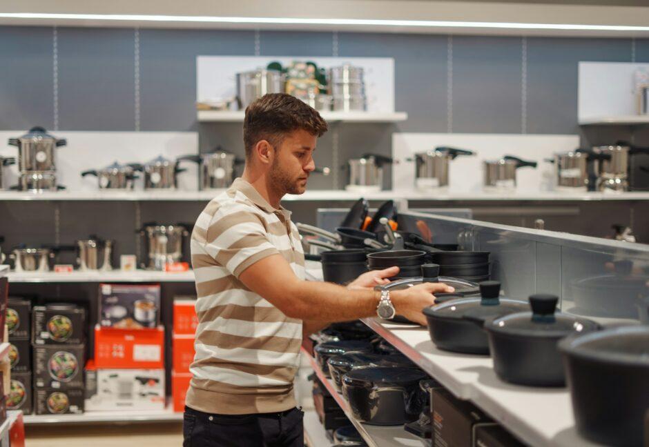 Man buying cooking pot in shop