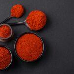 Spice smoked paprika in the form of powder in bowls and spoons